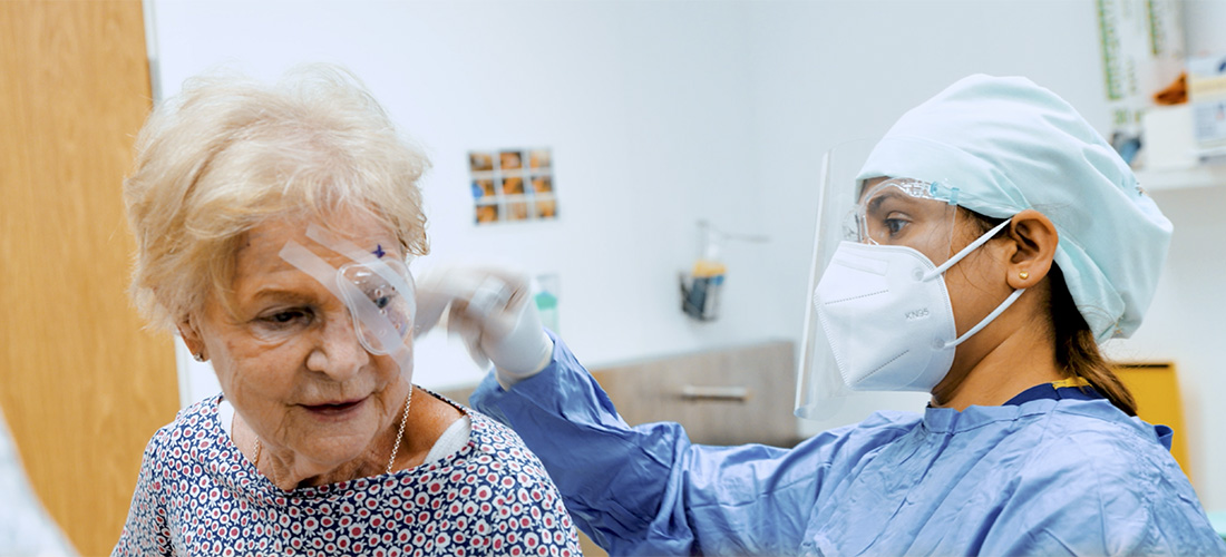 nurse treating elderly patient